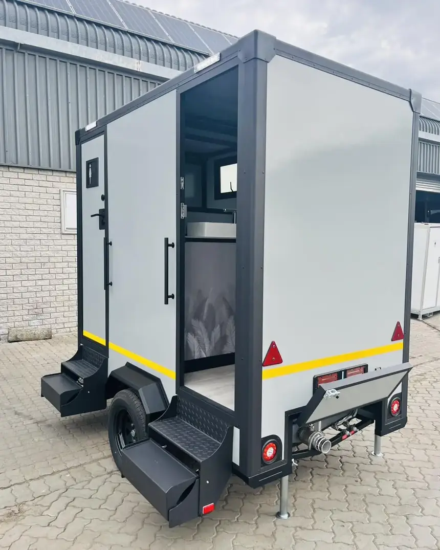 Restroom trailer exterior with fold-down steps