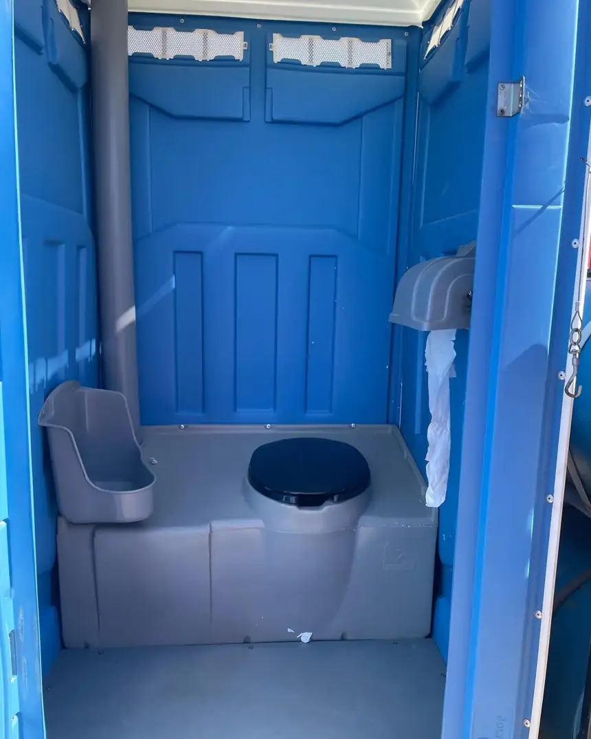 Standard porta potty interior with urinal and vent pipe